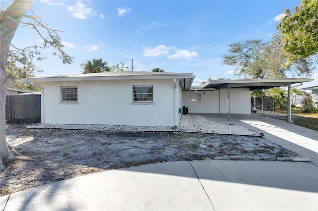 back of property with a carport