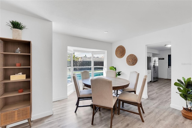 dining space with light wood-type flooring