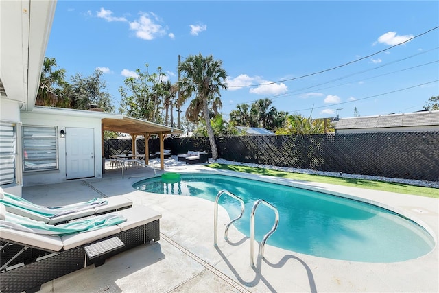 view of swimming pool with an outdoor living space and a patio