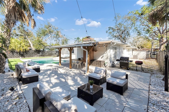 view of patio featuring an outdoor living space, a fenced in pool, and a grill