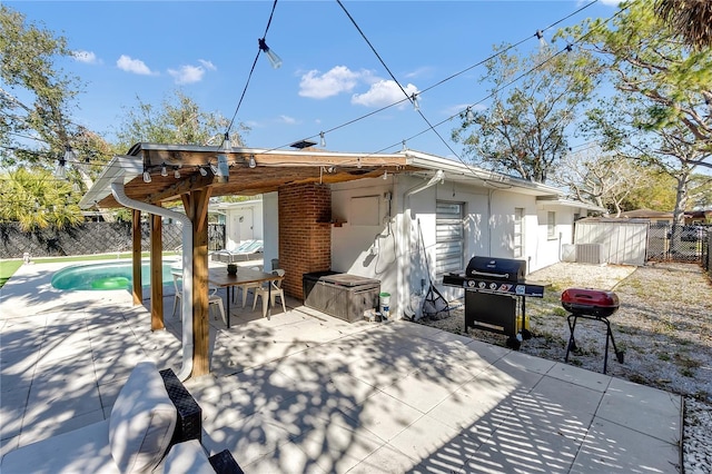 back of house with cooling unit, a fenced in pool, and a patio