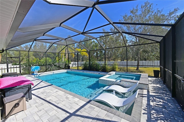 view of pool featuring a lanai, a patio area, and an in ground hot tub