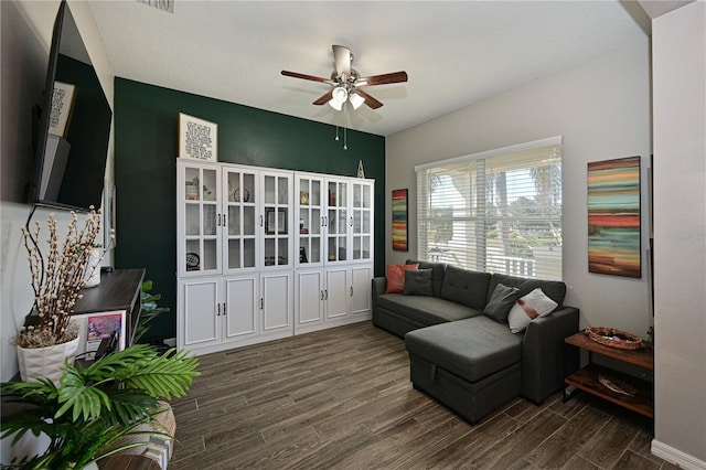 sitting room featuring dark wood-type flooring and ceiling fan