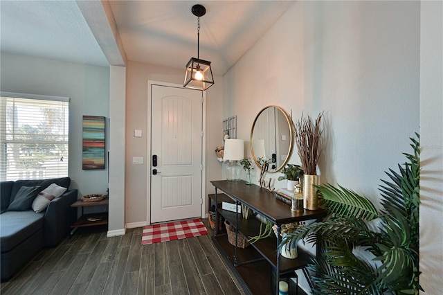 entryway with dark wood-type flooring and vaulted ceiling