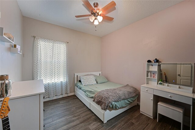 bedroom with dark wood-type flooring and ceiling fan