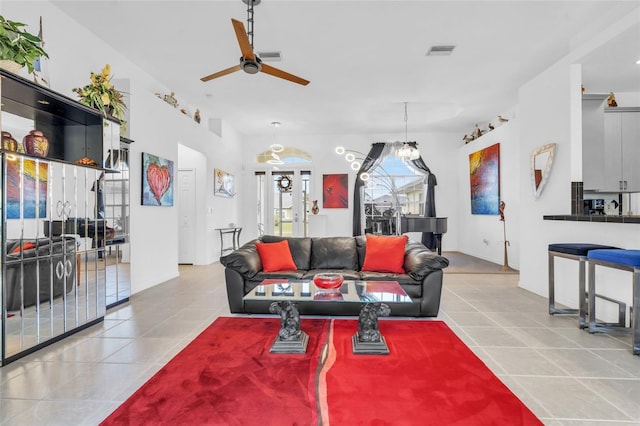 living room featuring ceiling fan and light tile patterned floors