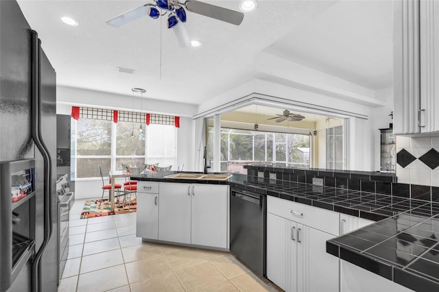 kitchen featuring black appliances, white cabinets, backsplash, tile counters, and kitchen peninsula