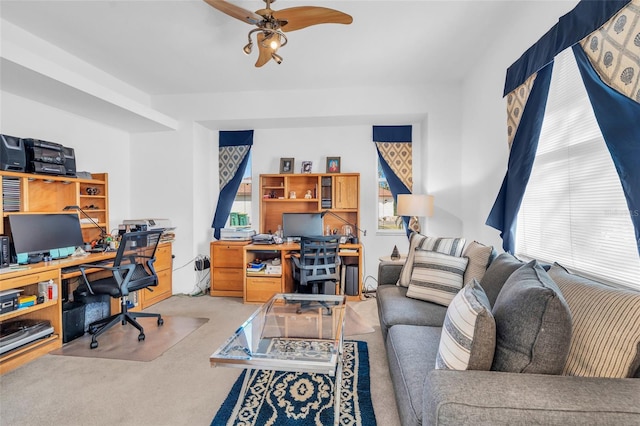 office space with light carpet and ceiling fan