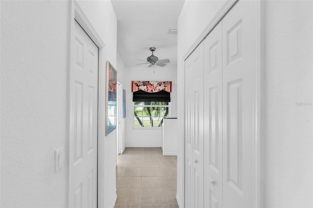 corridor with light tile patterned floors