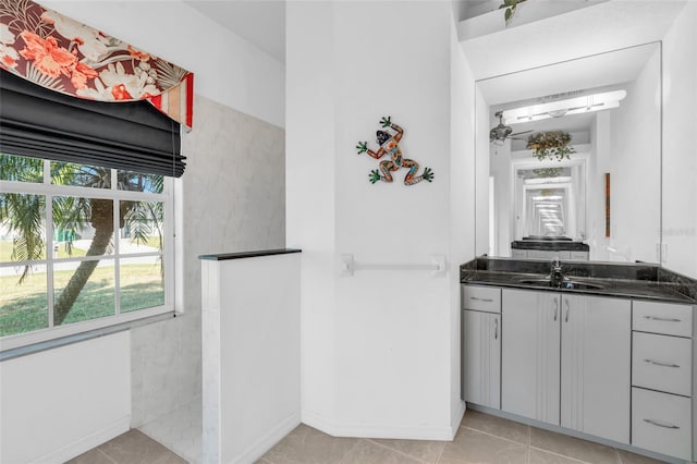 bathroom with vanity, ceiling fan, tile patterned floors, and a shower