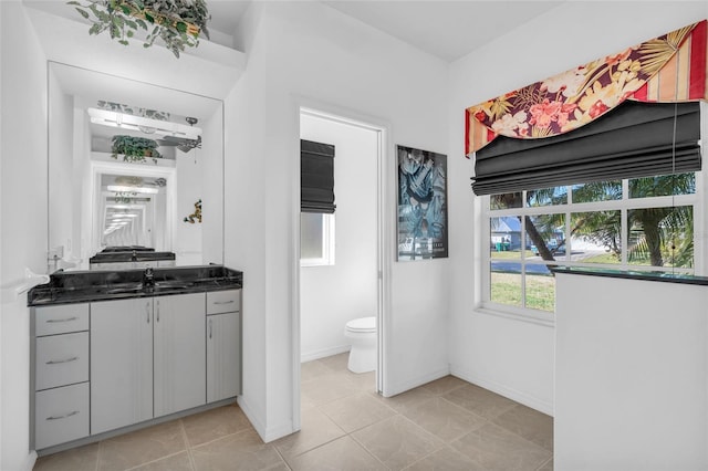 bathroom with vanity, tile patterned flooring, and toilet