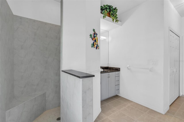 bathroom featuring vanity and tiled shower