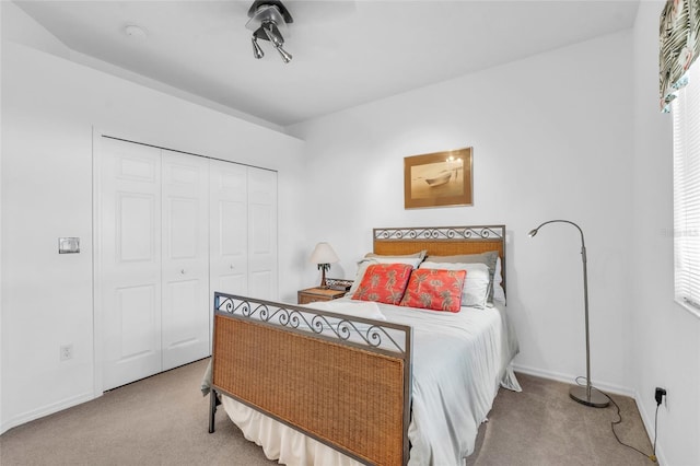 bedroom featuring light carpet and a closet