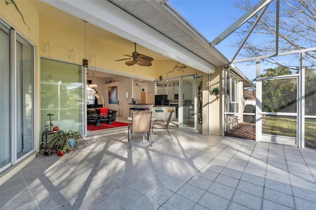 unfurnished sunroom with beamed ceiling and ceiling fan