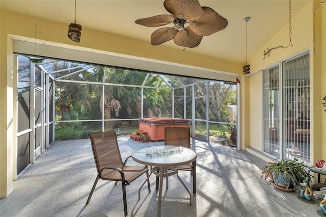 sunroom featuring lofted ceiling and ceiling fan