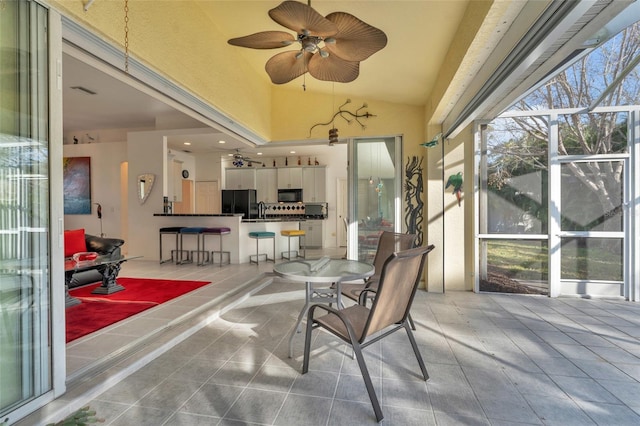 sunroom / solarium with sink and ceiling fan