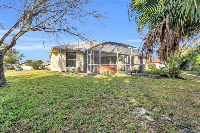 back of house featuring a yard and a lanai