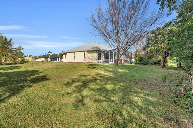 view of yard with glass enclosure