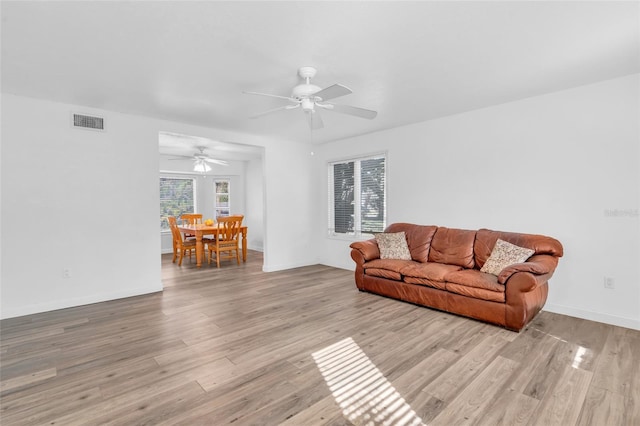 living room with ceiling fan and light hardwood / wood-style floors