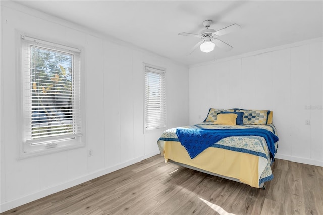 bedroom with hardwood / wood-style flooring and ceiling fan