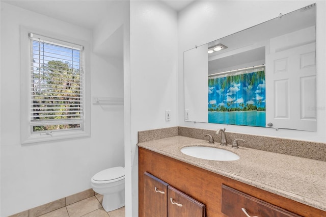 bathroom featuring vanity, toilet, and tile patterned flooring