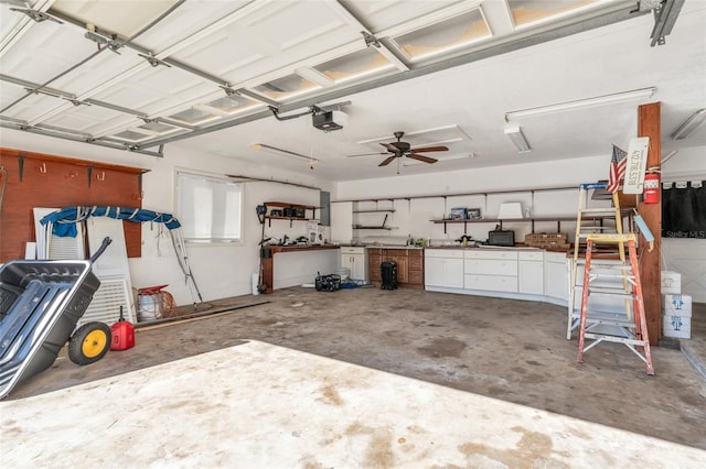 garage featuring a garage door opener and a workshop area