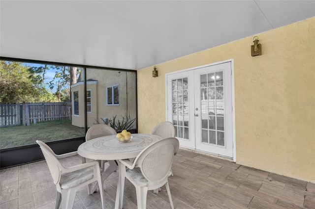 sunroom / solarium featuring french doors