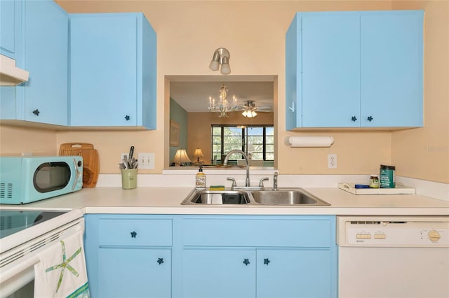 kitchen with white dishwasher, sink, pendant lighting, and blue cabinetry