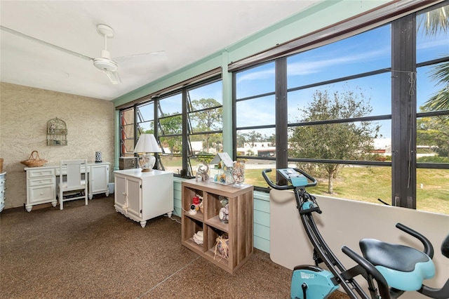 sunroom / solarium featuring ceiling fan