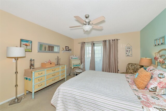 carpeted bedroom with a textured ceiling and ceiling fan