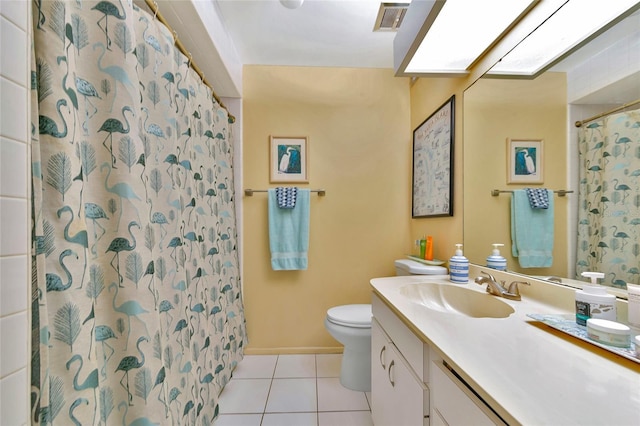 bathroom with vanity, toilet, curtained shower, and tile patterned flooring