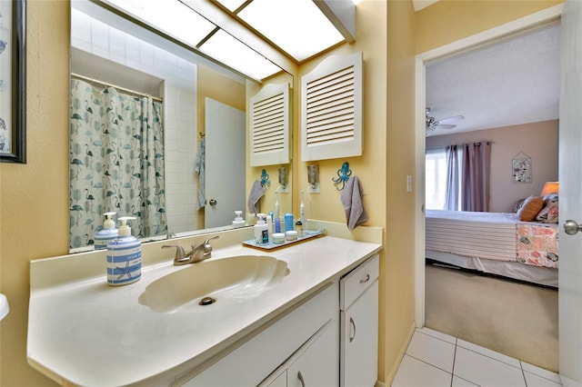 bathroom featuring vanity, tile patterned floors, ceiling fan, and a skylight