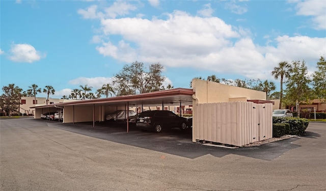 view of parking / parking lot featuring a carport