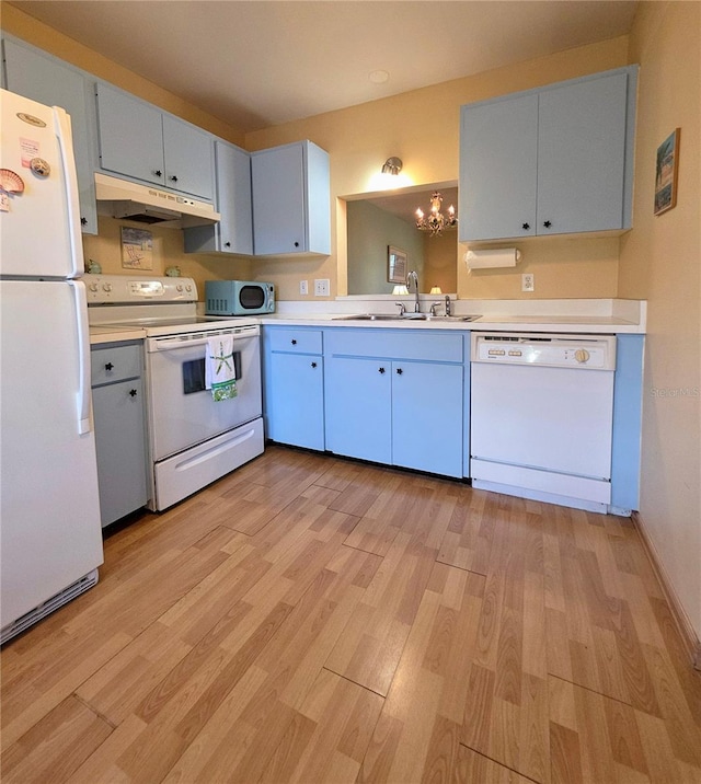 535 Spring Lakes Blvd, Bradenton, FL 34210 - kitchen featuring white appliances, under cabinet range hood, a chandelier, and light countertops