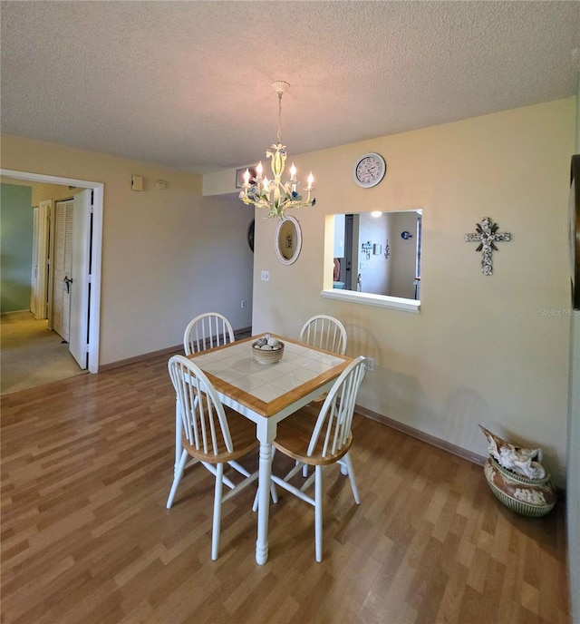 535 Spring Lakes Blvd, Bradenton, FL 34210 - dining room with wood finished floors, a chandelier, and a textured ceiling