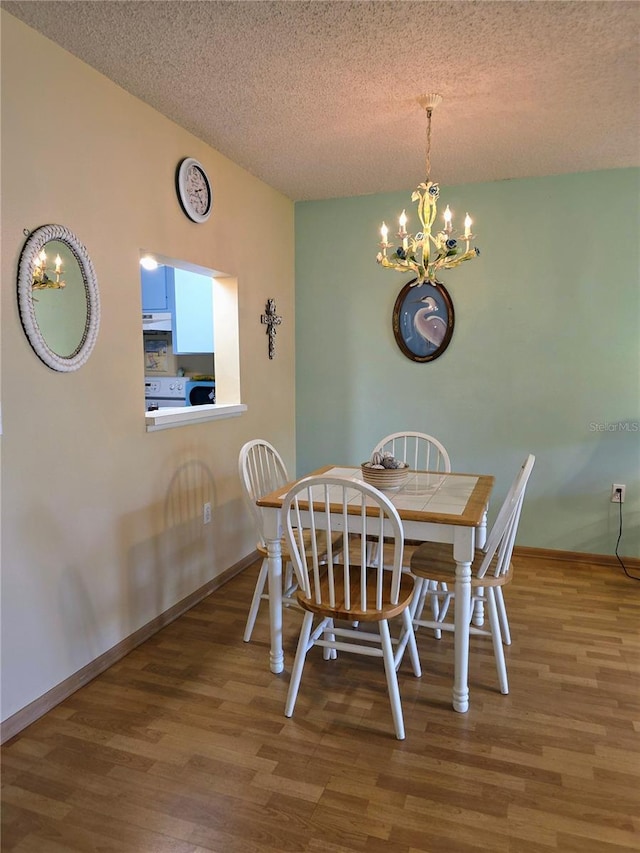 535 Spring Lakes Blvd, Bradenton, FL 34210 - dining room with a chandelier, wood finished floors, and a textured ceiling