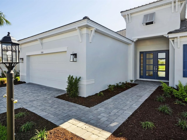 doorway to property featuring french doors and a garage