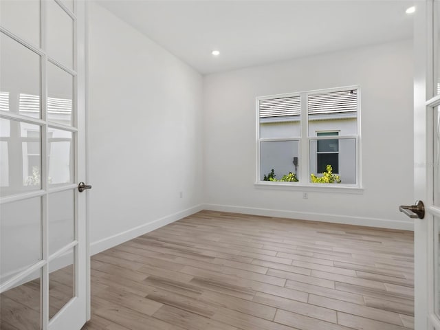 unfurnished room featuring a healthy amount of sunlight and light hardwood / wood-style flooring