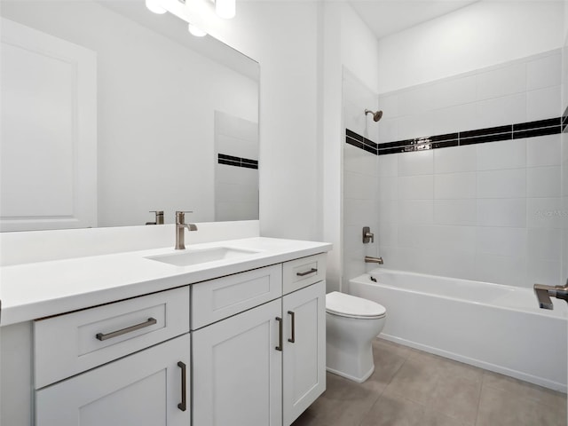 full bathroom with vanity, tile patterned flooring, tiled shower / bath combo, and toilet