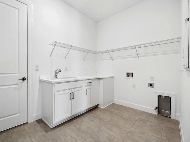 laundry area featuring electric dryer hookup, sink, washer hookup, and light tile patterned floors