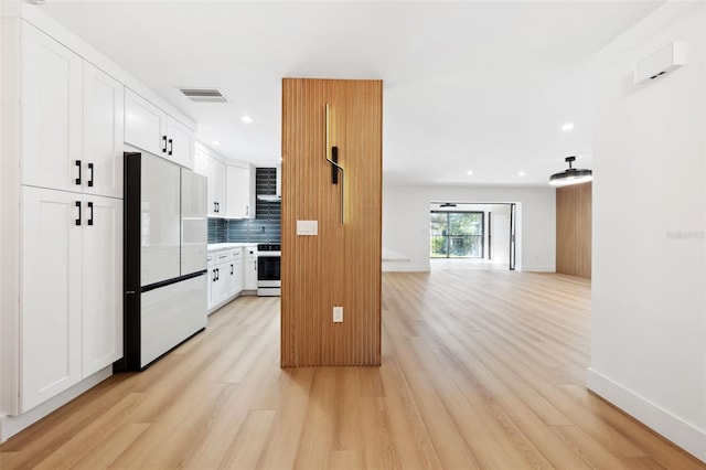 kitchen featuring refrigerator, backsplash, white cabinets, range, and light hardwood / wood-style flooring