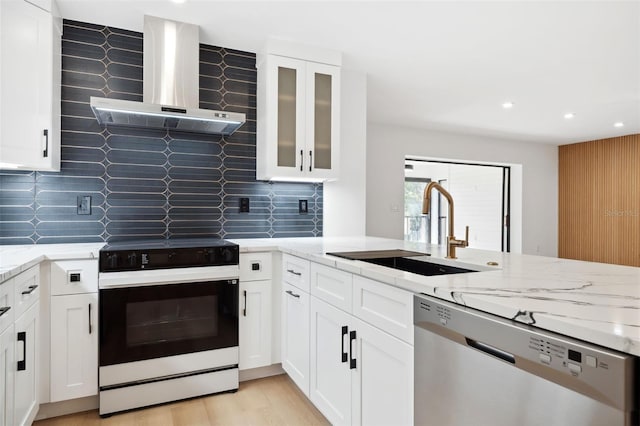 kitchen featuring wall chimney exhaust hood, sink, electric range oven, dishwasher, and white cabinets