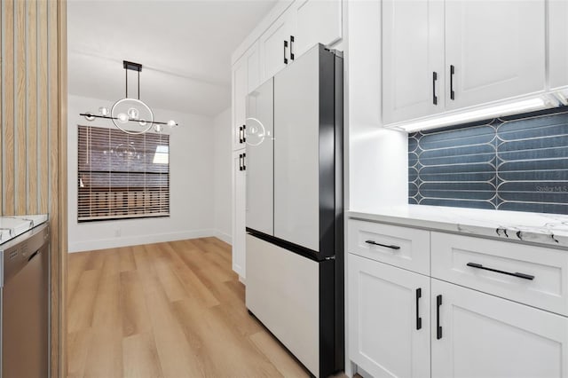 kitchen featuring dishwasher, fridge, decorative backsplash, white cabinets, and decorative light fixtures