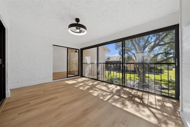 interior space featuring a textured ceiling and light wood-type flooring