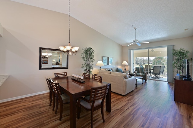 dining room with high vaulted ceiling, dark wood-type flooring, ceiling fan with notable chandelier, and a textured ceiling