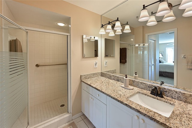 bathroom featuring vanity, tile patterned flooring, and walk in shower