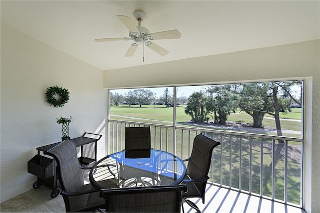 sunroom with ceiling fan and lofted ceiling