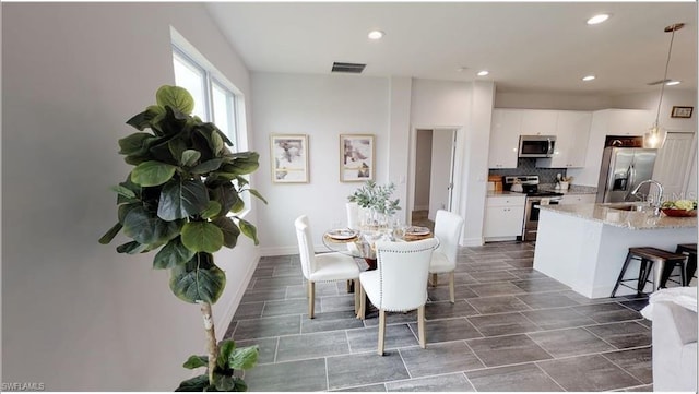 dining space featuring sink