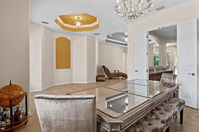 interior space featuring a raised ceiling, ornamental molding, and a chandelier