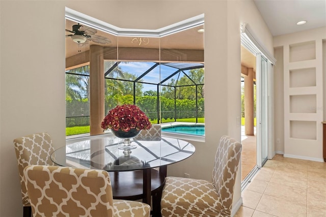 sunroom / solarium featuring ceiling fan